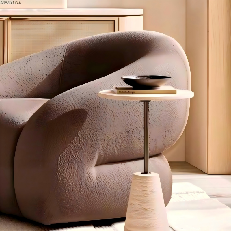 Italian luxury round travertine side table with gold stainless steel pole beside modern sofa