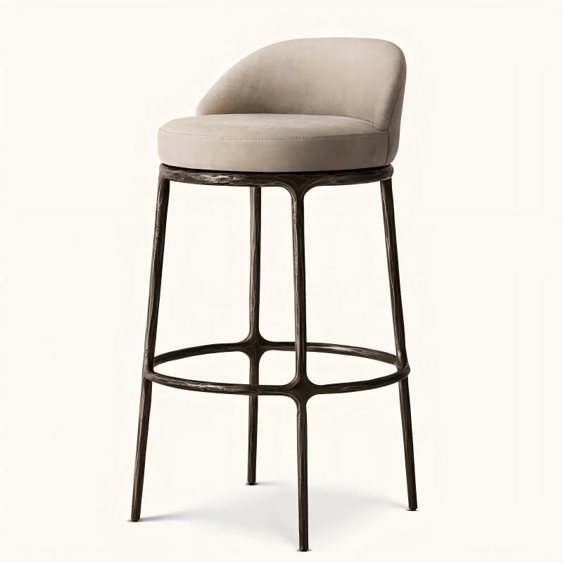 Low‑back upholstered bar stool, hand forged textured metal frame, beige velvet cushion, luxury villa kitchen bar scene display, hospitality export furniture